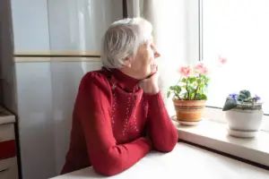Patient Advocacy concept older woman looking out window